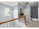 Second story hallway with chair rail, carpeted floor, overhead lighting and wooden staircase at 5224 Stonewall Dr, Summerville, SC 29485