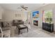Cozy living room with a fireplace, neutral color scheme, and abundant natural light at 5224 Stonewall Dr, Summerville, SC 29485