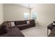 Cozy living room featuring a large sectional couch and natural light from two windows at 5224 Stonewall Dr, Summerville, SC 29485