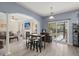 Open-concept living room with ample natural light, a bar table, and sliding glass doors to the backyard at 5224 Stonewall Dr, Summerville, SC 29485