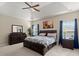 Spacious main bedroom featuring tray ceilings, a ceiling fan, plush carpet, and abundant natural light at 5224 Stonewall Dr, Summerville, SC 29485