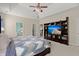 Bright main bedroom with a ceiling fan, built in entertainment center, and an ensuite bath at 5224 Stonewall Dr, Summerville, SC 29485