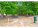 Picturesque picnic area featuring vibrant blue picnic tables and charcoal grills amidst lush greenery at 5224 Stonewall Dr, Summerville, SC 29485