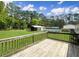 Backyard features a deck, swimming pool, large backyard, and mature trees at 570 Crystal Shores Dr, Moncks Corner, SC 29461