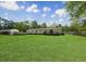 Spacious backyard featuring a deck, above-ground pool, and lush lawn at 570 Crystal Shores Dr, Moncks Corner, SC 29461
