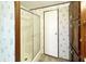 Bathroom with shower, floral wallpaper, vanity, and cabinets at 570 Crystal Shores Dr, Moncks Corner, SC 29461