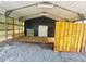 Interior of the metal carport, showing the gravel flooring and materials stored inside at 570 Crystal Shores Dr, Moncks Corner, SC 29461