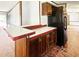 Cozy kitchen with black appliances, including refrigerator, dark cabinetry and an island at 570 Crystal Shores Dr, Moncks Corner, SC 29461