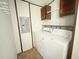 Laundry room with white washer, dryer, and overhead cabinets at 570 Crystal Shores Dr, Moncks Corner, SC 29461