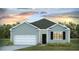 Charming single-story home with light blue siding, a gray roof, and an attached garage at 6246 Gritman Dr, Hollywood, SC 29470