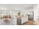 Bright, open kitchen featuring stainless steel appliances, granite countertops, and seamless flow to the living area at 6246 Gritman Dr, Hollywood, SC 29470