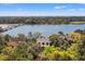 An aerial view showcasing a home near a scenic lagoon and a picturesque golf course, surrounded by lush trees at 66 New Settlement Rd, Kiawah Island, SC 29455
