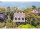 Stunning aerial view of waterfront home with lush, mature landscaping and inviting front porch at 66 New Settlement Rd, Kiawah Island, SC 29455