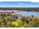 An aerial view showcasing a home near a scenic lagoon, surrounded by lush trees with a picturesque view of the coast at 66 New Settlement Rd, Kiawah Island, SC 29455