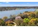 An aerial view showcasing the home overlooking a scenic lagoon and a picturesque golf course, surrounded by lush trees at 66 New Settlement Rd, Kiawah Island, SC 29455