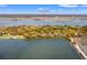 An aerial view of 66 New Settlement showcasing a picturesque lagoon and a nearby golf course on Kiawah Island at 66 New Settlement Rd, Kiawah Island, SC 29455