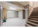 Spacious basement with concrete walls, wood paneling, exposed pipes, and a staircase leading to the upper level at 66 New Settlement Rd, Kiawah Island, SC 29455
