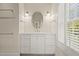 Bathroom with white vanity and an oval mirror at 66 New Settlement Rd, Kiawah Island, SC 29455