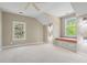 Cozy bedroom featuring a window seat, two windows, sconces, and ceiling fan at 66 New Settlement Rd, Kiawah Island, SC 29455