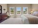 Sunlit bedroom featuring large windows with a view of the water, a chair, and dresser at 66 New Settlement Rd, Kiawah Island, SC 29455