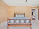 Bedroom featuring a wooden bamboo bed frame and textured wallpaper at 66 New Settlement Rd, Kiawah Island, SC 29455