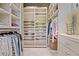 Organized walk-in closet with shelves for shoes and folded clothes, and hanging racks for clothes at 66 New Settlement Rd, Kiawah Island, SC 29455