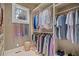 Spacious walk-in closet with built-in shelving, hanging rods, and a window for natural light at 66 New Settlement Rd, Kiawah Island, SC 29455