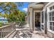 Open doors to a large wooden deck featuring outdoor dining and lounge area with water views at 66 New Settlement Rd, Kiawah Island, SC 29455