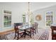 Bright dining room featuring a wood table, patterned rug, elegant chandelier, and white trim at 66 New Settlement Rd, Kiawah Island, SC 29455