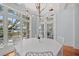 Elegant dining room with bright windows and access to the water view deck through glass doors at 66 New Settlement Rd, Kiawah Island, SC 29455
