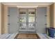 Exterior gray double doors with glass panels leading to outdoor area with plants at 66 New Settlement Rd, Kiawah Island, SC 29455