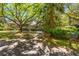 Long driveway leading to a charming two-story home, shaded by mature trees and lush landscaping at 66 New Settlement Rd, Kiawah Island, SC 29455