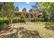 Charming two-story home with a manicured front lawn, symmetrical landscaping, and a welcoming front porch at 66 New Settlement Rd, Kiawah Island, SC 29455