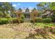 Charming two-story home with a manicured front lawn, symmetrical landscaping, and a welcoming front porch at 66 New Settlement Rd, Kiawah Island, SC 29455
