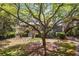 Beautifully landscaped front yard with a charming two-story home partially shaded by a mature tree at 66 New Settlement Rd, Kiawah Island, SC 29455