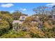 Inviting exterior view of a well-maintained home with mature trees and a spacious front porch at 66 New Settlement Rd, Kiawah Island, SC 29455