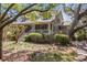 Attractive two-story home with a cozy front porch, accented by mature trees and meticulously maintained landscaping at 66 New Settlement Rd, Kiawah Island, SC 29455