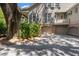 Two-car garage with brick accents and a private balcony above, shaded by a large tree at 66 New Settlement Rd, Kiawah Island, SC 29455