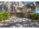 Two-car garage with brick accents and a private balcony above, nestled among lush greenery at 66 New Settlement Rd, Kiawah Island, SC 29455