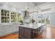Bright modern kitchen with white cabinets, large island, stainless steel appliances and large windows at 66 New Settlement Rd, Kiawah Island, SC 29455