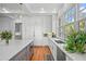 Modern kitchen with white cabinetry, a large island, and updated appliances, blending style and functionality at 66 New Settlement Rd, Kiawah Island, SC 29455