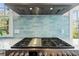 Close-up of the kitchen's professional range with a stylish backsplash, highlighting modern design at 66 New Settlement Rd, Kiawah Island, SC 29455