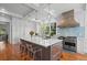 Large kitchen island with white countertop, brown cabinets and pendant lights at 66 New Settlement Rd, Kiawah Island, SC 29455