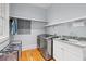 Functional laundry room with modern washer and dryer, sink, and storage shelves at 66 New Settlement Rd, Kiawah Island, SC 29455