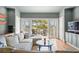 Cozy living room with a sectional sofa, hardwood floors, and outdoor deck access with scenic views at 66 New Settlement Rd, Kiawah Island, SC 29455