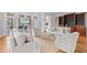Bright living room with a view of the outdoor patio, neutral furniture and a wall of built-in shelving at 66 New Settlement Rd, Kiawah Island, SC 29455