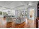 Elegant living room open to the kitchen, featuring stylish sofas and access to an outdoor deck at 66 New Settlement Rd, Kiawah Island, SC 29455