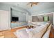 Warm and inviting living room showcasing hardwood floors, a sectional sofa, and custom built-in cabinets at 66 New Settlement Rd, Kiawah Island, SC 29455