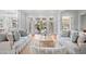 Bright living room with French doors opening to outdoor views, furnished with stylish seating and decor at 66 New Settlement Rd, Kiawah Island, SC 29455