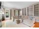 Spacious living room featuring a large sectional sofa, hardwood floors, and custom built-in shelves at 66 New Settlement Rd, Kiawah Island, SC 29455